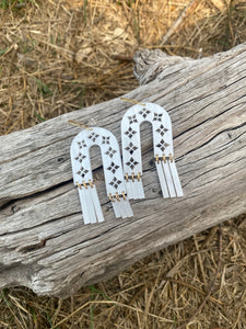 Arches and Fringe cut-out earrings in pearl-sheen acrylic with brass