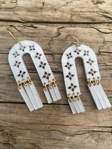 Arches and Fringe cut-out earrings in pearl-sheen acrylic with brass